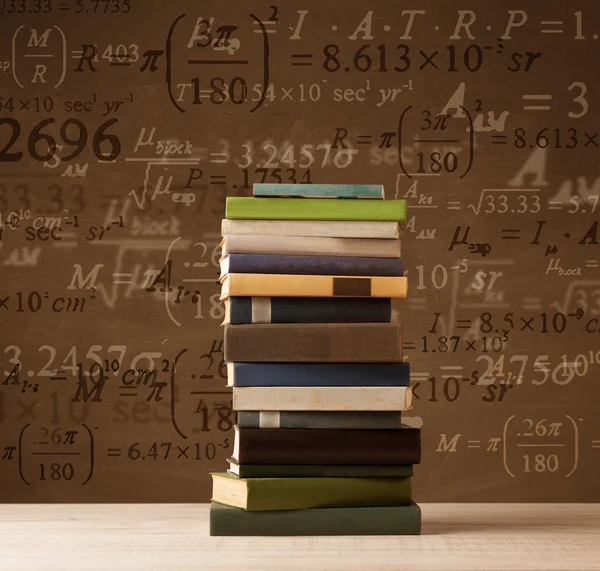 Книги на винтажном фоне с математическими формулами — стоковое фото