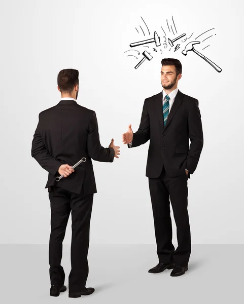 Businessman hiding a weapon — Stock Photo, Image