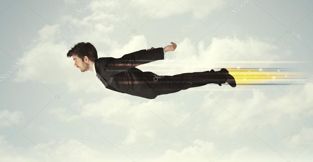 Happy business man flying fast on the sky between clouds