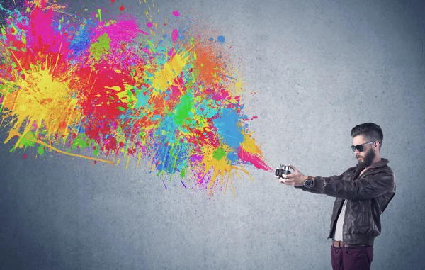 Hipster guy with camera and paint splash — Stock Photo, Image