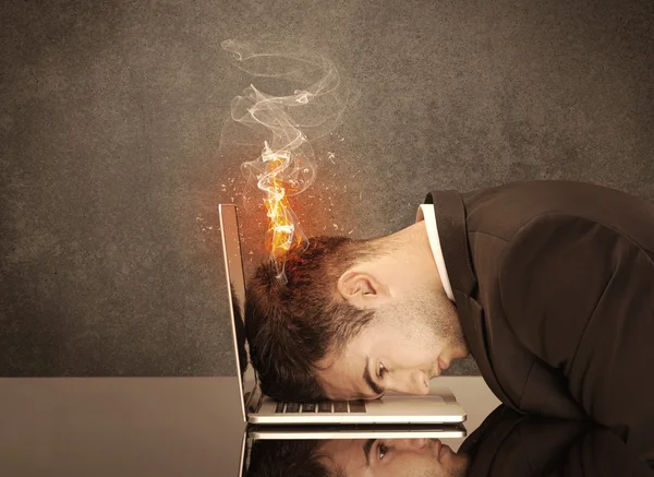 Sad business person's head catching fire