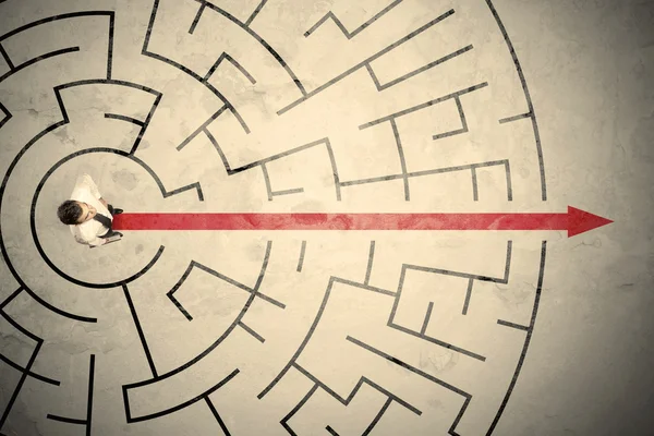 Business person standing in the middle of a circular maze — Stock Photo, Image