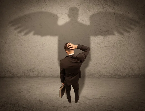 Honest salesman with angel shadow concept — Stock Photo, Image