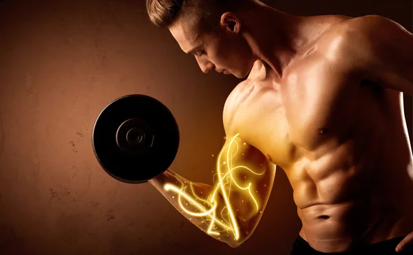 Muscular body builder lifting weight with energy lights on bicep — Stock Photo, Image