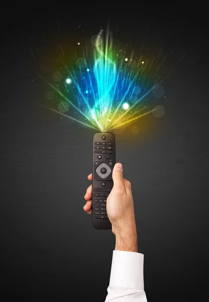 Hand with remote control and explosive signal — Stock Photo, Image