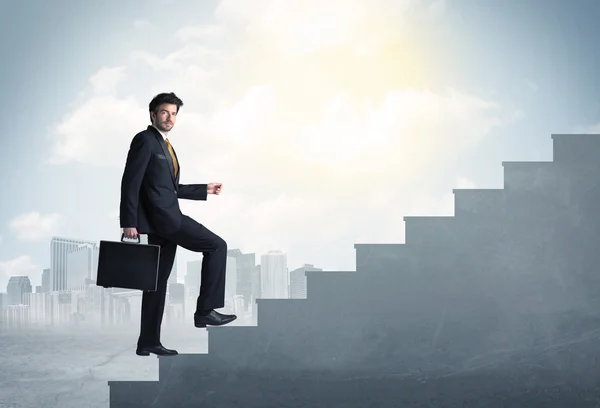 Businessman climbing up a concrete staircase concept — Stock Photo, Image