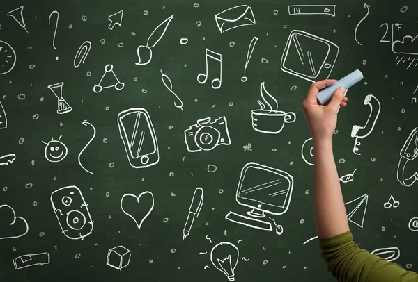 Hand writing icons on blackboard — Stock Photo, Image