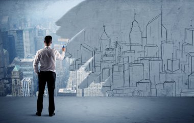 Zarif satıcı şehri duvarda yeniden boyuyor.