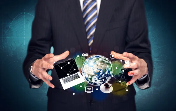 Business person holding laptop and globe — Stock Photo, Image