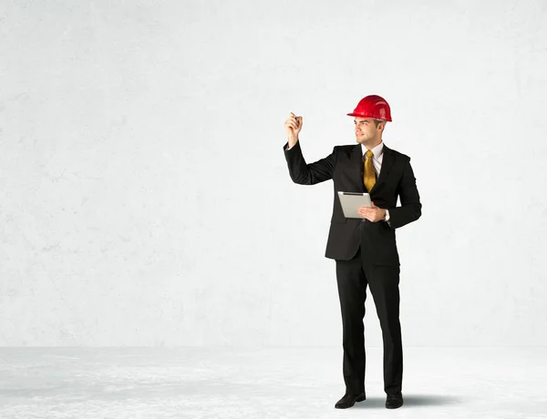 Young architect drawing in empty space — Stock Photo, Image