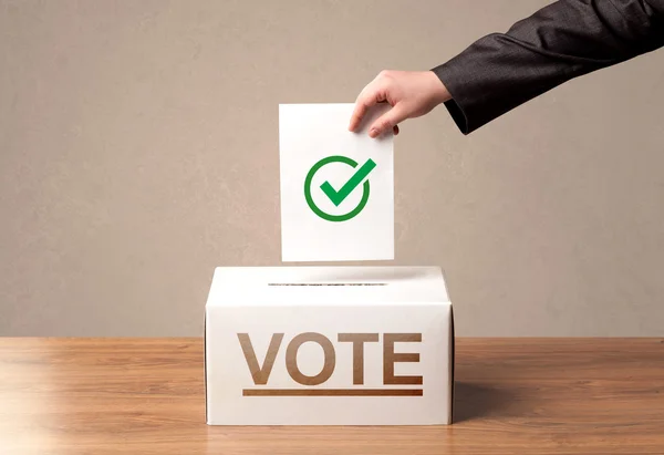 Close up of male hand putting vote into a ballot box — Stock Photo, Image