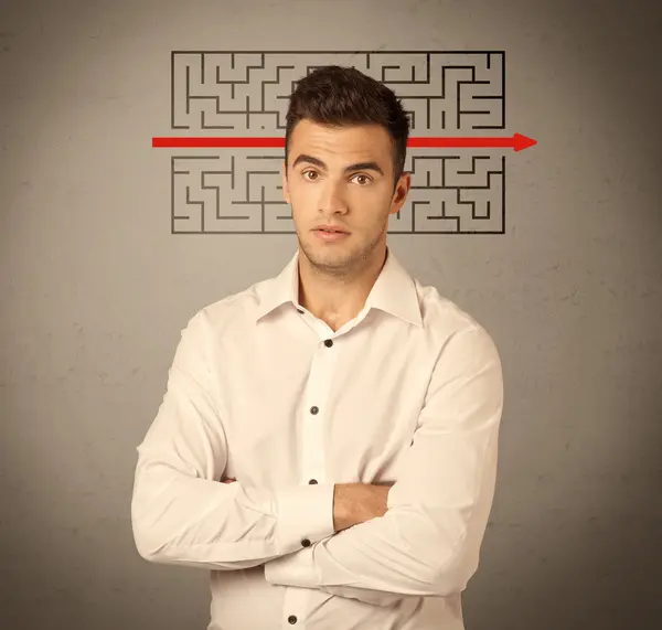 Handsome business guy solving maze — Stock Photo, Image