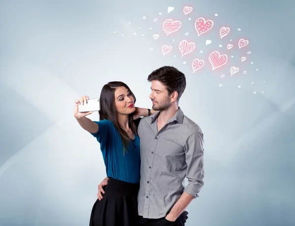 Para zakochanych robi selfie z czerwonym sercem — Zdjęcie stockowe