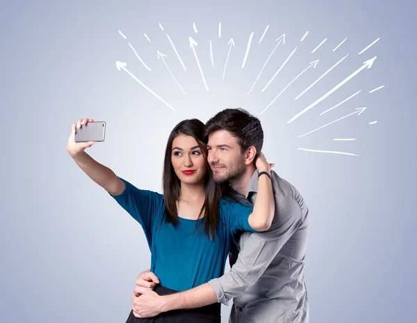 Cute couple taking selfie with arrows — Stock Photo, Image