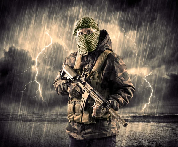 Dangerous armed terrorist with mask and gun in a thunderstorm wi — Stock Photo, Image