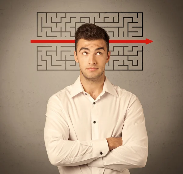 Handsome business guy solving maze — Stock Photo, Image