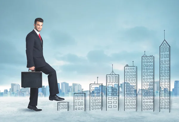 Business man climbing up on hand drawn buildings in city — Stock Photo, Image