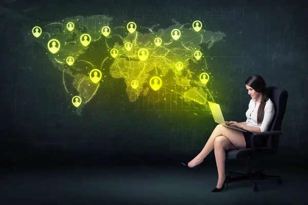 Businesswoman in office with laptop and social network world map — Stock Photo, Image