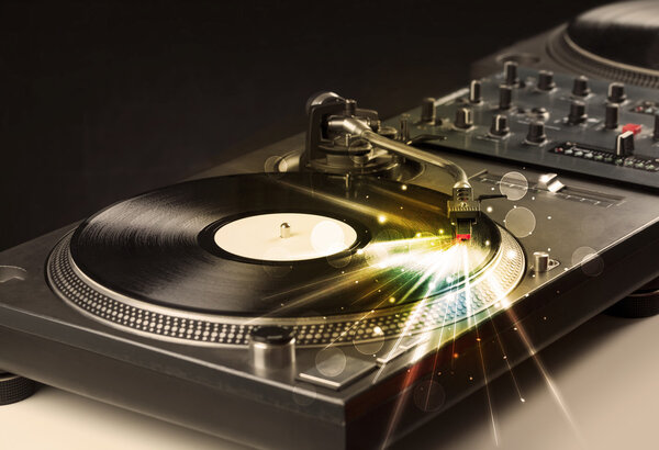 Music player playing vinyl with glow lines coming from the need
