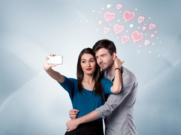 Couple in love taking selfie with red heart — Stock Photo, Image