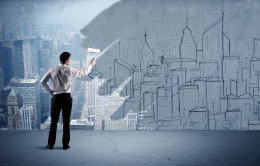 Zarif satıcı şehri duvarda yeniden boyuyor.