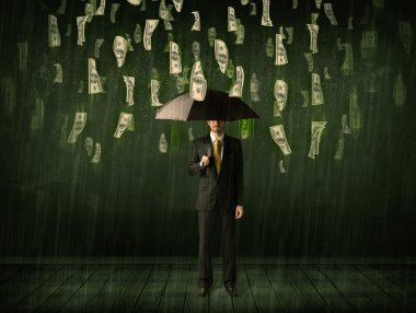 Bir dolar yağmur konseptinde şemsiyesi olan bir iş adamı