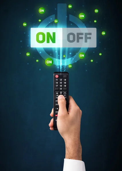 Hand with remote control and on-off signals