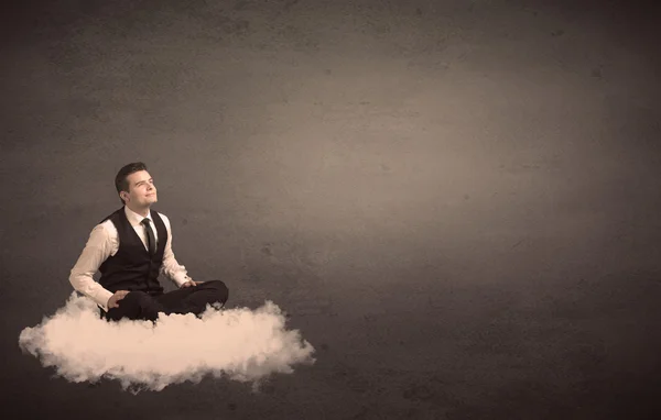 Man sitting on a cloud with plain background — Stock Photo, Image