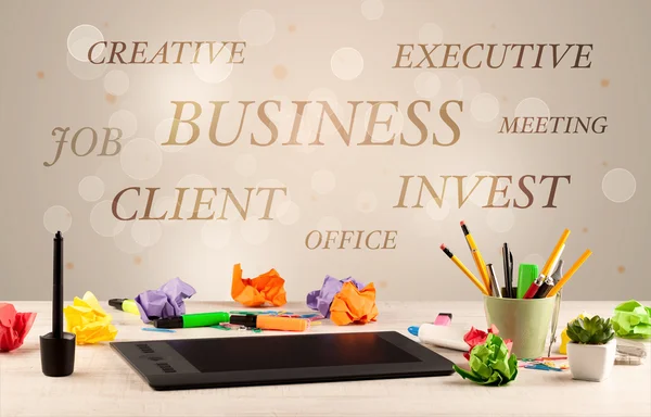 Business office desk with writing on wall — Stock Photo, Image