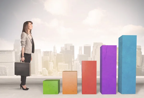 Business person climbing up on colourful chart pillars concept — Stock Photo, Image