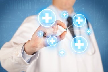 Haçlı bir hap gösteren bir doktor.