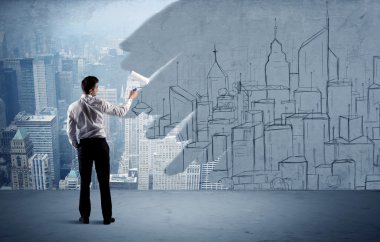 Zarif satıcı şehri duvarda yeniden boyuyor.