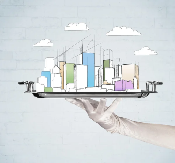 Hand serving city and clouds on tray — Stock Photo, Image