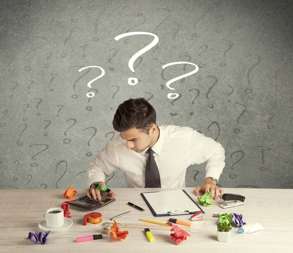 Businessman at desk with question mark — Stock Photo, Image