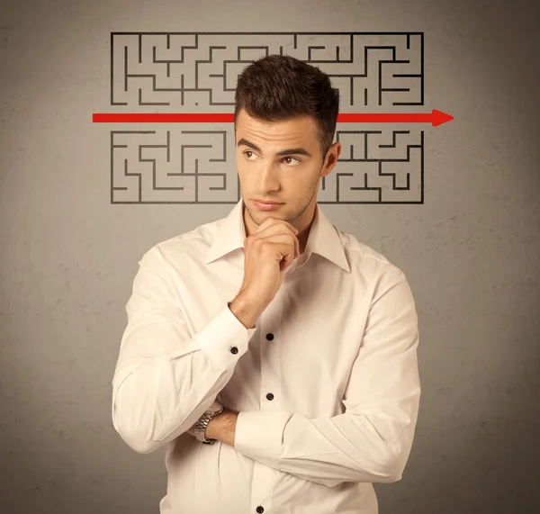 Handsome business guy solving maze — Stock Photo, Image