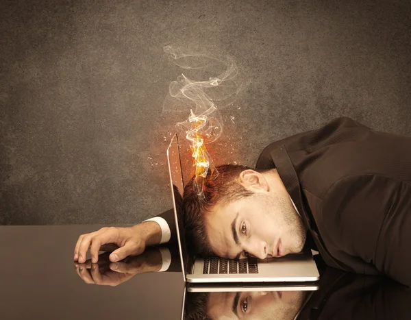 Sad business person's head catching fire