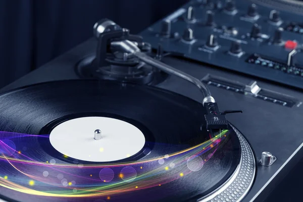 Turntable playing vinyl with glowing abstract lines — Stock Photo, Image