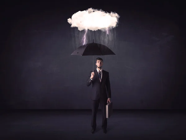 Empresário de pé com guarda-chuva e pouca nuvem de tempestade — Fotografia de Stock