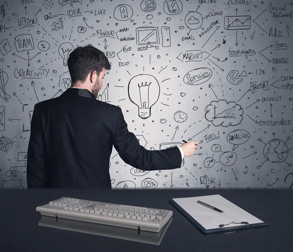 Businessman writing strategy plan on wall — Stock Photo, Image