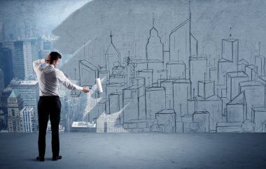 Zarif satıcı şehri duvarda yeniden boyuyor.