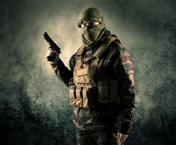 Porträtt av en tungt beväpnade maskerade soldat med grungy bak — Stockfoto