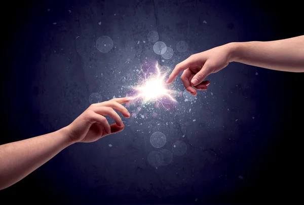 Hands reaching to light a spark