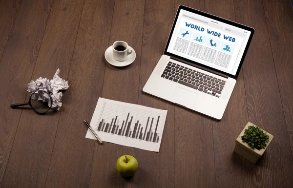 Laptop na mesa de madeira com suplies de escritório — Fotografia de Stock