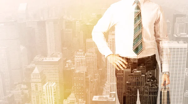 Business man looking at overlay city background — Stock Photo, Image