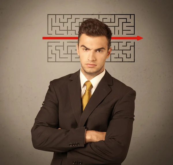 Handsome business guy solving maze — Stock Photo, Image