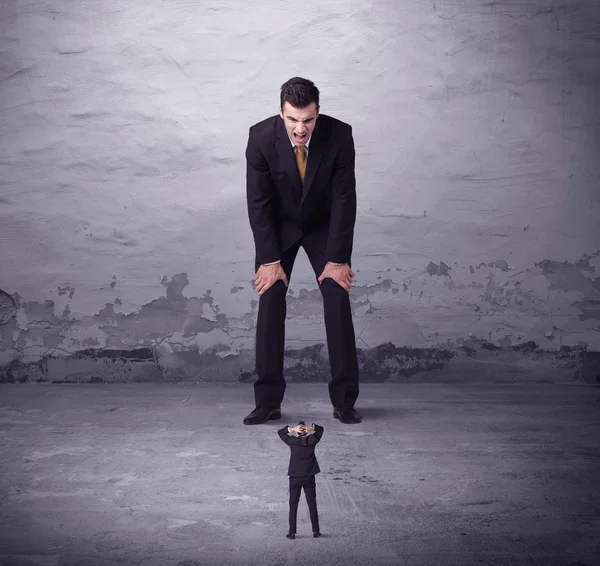 Angry big manager looking at small business man — Stock Photo, Image