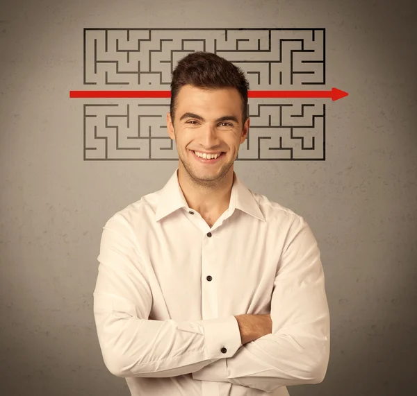 Handsome business guy solving maze — Stock Photo, Image