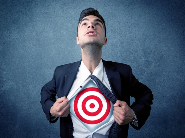 Businessman tearing shirt with target sign on his chest — Stock Photo, Image