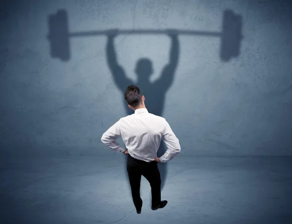 Businessman with weight lifting shadow — Stock Photo, Image