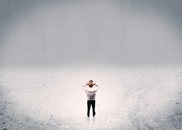 Businessman standing in urban empty space — Stock Photo, Image